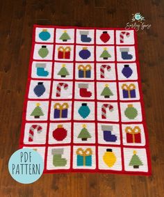 a crocheted christmas quilt on a wooden floor