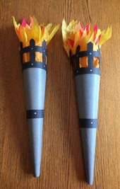 two paper cones with fire on them sitting on a table