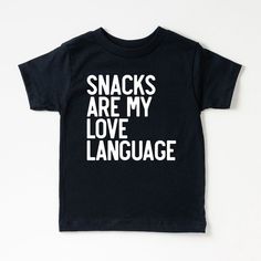 Looking for a cute tee for your kids? We have the perfect Snacks Are My Love Language graphic tee addition to their closet! Also available in toddler tees. Popular Shirts Vinyl, Black Family Matching T-shirt For Playtime, Casual Tops With Funny Text For Playtime, Funny Letter Print T-shirt For Playtime, Black Letter Print T-shirt For Playtime, Black T-shirt With Letter Print For Playtime, Cute Black T-shirt With Funny Text, Toddler Cricut Shirts, Kids Vinyl Shirt Ideas