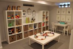 a child's playroom with toys and bookshelves