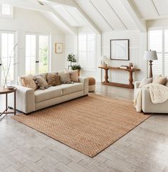 a living room with two couches and a rug