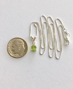 Genuine small peridot measures 6x4mm ( just under 1/2 carat) and genuine tiny accent diamond. Both stones were handset in sterling silver. Sterling silver box chain is 18 inches long and can be switched out to a 16 inch chain upon request. Necklace is perfect for a child or the minimalist. Comes in a gift box Elegant Green Peridot Birthstone Necklace, Green Peridot Necklace For Gift, Gold Peridot Round Pendant Necklace, Green Peridot Gemstone Necklace, Necklace Green Stone, Ruby Heart Necklace, Gift Peridot Faceted Necklaces, Purple Stone Necklace, August Birthstone Necklace