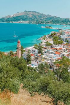 an aerial view of the city and ocean with mountains in the backgrouds