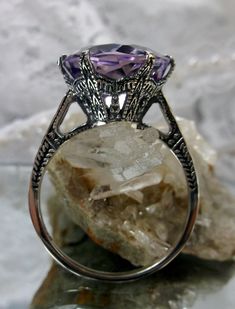 Natural Purple Amethyst Ring 100 Year Design#37 This is a brand new Edwardian reproduction filigree ring in antiqued solid sterling silver. The round full cut high-quality 5ct Natural Purple Amethyst gemstone is 12mm in diameter. The inside of the band is marked 925 for sterling. Notice the beautiful intricate crown-like design of the silver filigree setting and etched band. The original ring I bought in this exact design was from 1910. This is a rare and exact replica of that ring. A gift box i Antique Amethyst Promise Ring, Antique Hallmarked Amethyst Promise Ring, Victorian Amethyst Promise Ring Hallmarked, Victorian Hallmarked Amethyst Promise Ring, Art Deco Purple Amethyst Ring For Anniversary, Victorian Purple Rings For Wedding, Art Deco Purple Rings As A Gift, Purple Amethyst Art Deco Ring For Anniversary, Art Deco Purple Rings For Gift