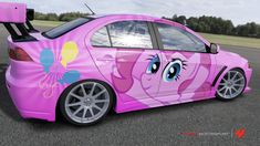 a pink car with an image of a pony painted on it's side, parked in a parking lot