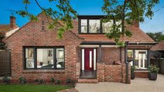 a brick house with a red front door