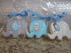 three decorated cookies in the shape of elephants