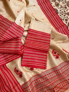 This is a creation of the master weavers of Bengal , Fulia . This saree is made of pure gachhi by gachhi  tussar and the border snd pallu is pure silk  . Very easy to carry it . One side has broad border other narrow . The colour has an  unique combinations .  Saree comes with a running blouse piece .  As it is entirely handmade so some irregularities is the mark of originality of handloom product.  With Silk mark certificate of India Government .  Fall and pico , tassel done and complimentary .  Note : Please leave your phone no and email id for shipping purpose. Cotton Silk Saree With Woven Motifs For Puja, Handloom Tussar Silk Saree For Traditional Ceremonies, Navratri Semi-stitched Weaving Work Dupatta, Navratri Semi-stitched Dupatta With Weaving Work, Raw Silk Blouse Piece With Weaving For Puja, Festive Red Blouse Piece With Weaving Work, Festive Red Blouse With Weaving Work, Traditional Handloom Raw Silk Saree, Motif Slub Silk Saree For Puja