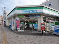 a family mart store on the corner of a street