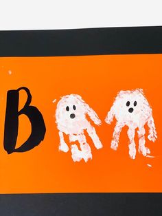 an orange and black sign with two white dogs on it's sides, the letter b