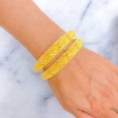 This pair of bangles is crafted from 22k gold, weighing a substantial 57.1 grams, and features a stunning yellow gold finish. Each bangle is sized at 2.8 inches with a 2.5-inch diameter, showcasing bold striped detailing that offers a look of extravagance and striking elegance. These bangles are not openable, which enhances their sleek and seamless silhouette. Ideal for those seeking to make a powerful fashion statement, this pair adds a touch of opulence and style to any ensemble, perfect for s Gold Bracelets For Diwali And Formal Occasions, Luxury Gold Bangle For Festive Season, Elegant Gold Plated Bracelets For Diwali, Yellow Bracelets With Intricate Design For Festivals, Yellow Gold Bracelet With Intricate Design For Wedding, Elegant 22k Gold Bangle For Diwali, Yellow Gold Filigree Bracelets For Festive Season, Festive Yellow Gold Filigree Bracelets, Yellow Bangle With Intricate Design