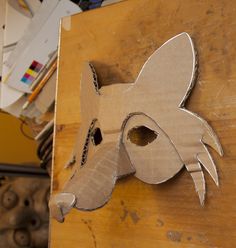 a cardboard cut out of a dog's head on top of a piece of plywood