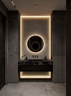 a bathroom with a sink, mirror and lights on the wall above it's counter