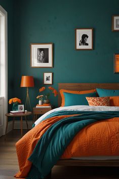 an orange and teal bedroom with pictures on the wall, bedding and pillows