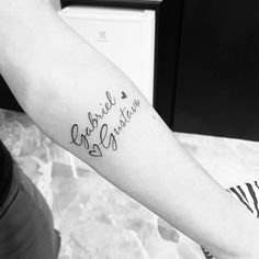 a person with a tattoo on their arm that says, angel and christmas written in cursive font