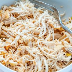 shredded chicken in a bowl with a fork