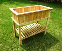 a wooden planter sitting on top of a lush green field