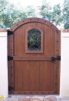 a wooden gate with a window in the middle