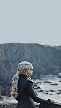 game of thrones'daeneress starke sitting on the rocks by the ocean