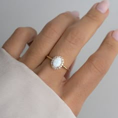 Beautiful opal ring featuring an oval cut with a pavé halo. It is absolutely stunning! Made of 925 Sterling Silver We use a THICK, DURABLE 14k Gold, Rose Gold, or Rhodium plating - for a piece that will last you years to come! Lab Created Opal- we use the highest grade for an authentic look VERY HIGH QUALITY Nickel-free & Hypoallergenic Available in sizes 4-10 Opal Stone w Halo: 10mm Opal Halo Engagement Ring, Simple Opal Engagement Ring, Unique Engagement Rings Opal, Opal Engagement Ring Silver, Dainty Promise Rings, Vintage Opal Rings, Senior Ring, Gold Opal Jewelry, Opal Ring Engagement