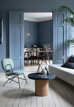 a living room with blue walls and furniture