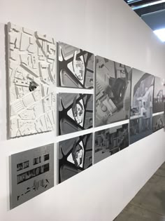 several black and white photographs hanging on the side of a wall next to each other