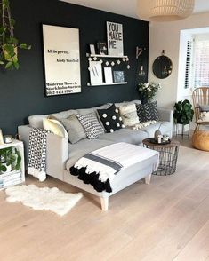 the living room is decorated in black and white with pops of color on the walls