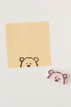 a piece of paper with a drawing of a bear on it next to a sticker