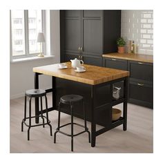 a kitchen island with two stools next to it