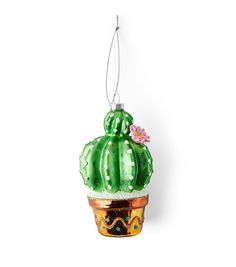 an ornament shaped like a cactus with flowers on it's head hanging from a cord