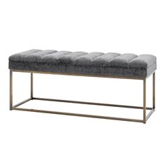 a gray bench with metal legs and a grey upholstered cushion on the top