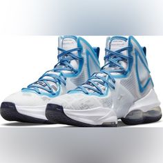 a pair of sneakers with blue laces on the upper part of their shoe, against a white background