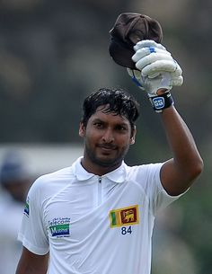 a man in white shirt holding up a baseball glove