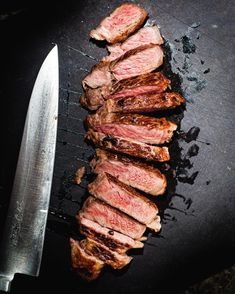 some meat is on a grill with a knife