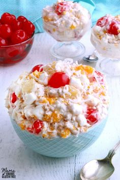 two bowls filled with fruit salad on top of a white table