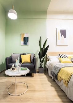 a living room with green walls and white furniture in the corner, along with a small coffee table