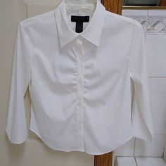 White Express Button Down Blouse, 3/4 Sleeves, Shirring In Front, Polyester, Nylon, Lycra Spandex Fitted Half-sleeve Blouse With Buttons, Fitted Half Sleeve Blouse With Buttons, Fitted Formal Shirt With 3/4 Sleeve, White Fitted Shirt With 3/4 Sleeves, Fitted White Shirt With 3/4 Sleeves, White 3/4 Sleeve Top With Button Closure, White Shirt With 3/4 Sleeves And Button Closure, Fitted Top With Buttons And 3/4 Sleeves, Formal Blouse With 3/4 Sleeves And Button Closure