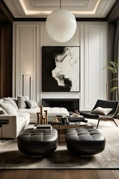 an elegant living room with black and white furniture, art work on the far wall