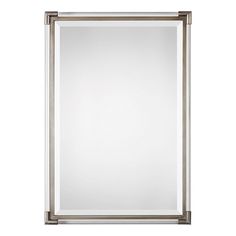 a large silver framed mirror on a white wall