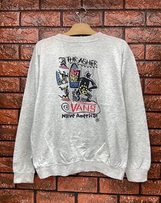 "Vintage 80s Vans Native Skateboard Pullover T Shirt / Old Skates T Shirt / 90s Vibe / 90s Streetwear / Made In Usa Size L Condition : Good Used Size on tag : L Colour : Grey Brand : Vans Measurement : Armpit to armpit - 22\" Length - 24\" Material : Old Cotton Made In: Usa THE SHIPPING (Your Choice Please read) 1. The shipping cost is USD 20 via Malaysian Registered Postage With Tracking Number. It will take 2-4 weeks or more for delivery, depends on your custom checking. 2. Add USD 10 for spee Casual Tops With Graffiti Print For Skateboarding, Casual Graffiti Print Tops, Casual Skateboarding Top With Front Print, Casual Crew Neck Sweatshirt With Graffiti Print, Casual Tops With Front Print For Skateboarding, Casual Front Print Tops For Skateboarding, Casual Long Sleeve Tops For Skateboarding, Cotton Graphic Print Sweatshirt For Skateboarding, Casual Graphic Print Sweatshirt For Surfing