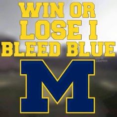 the michigan wolverines win or lose i bleed blue decal is shown in front of a blurry background