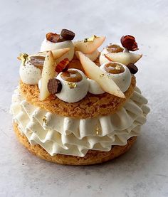 a pastry with apples and nuts on top