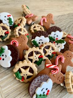 christmas cookies and candies on a table with candy canes in the shape of animals