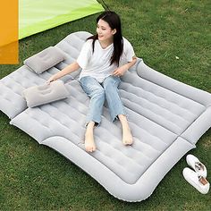 a woman is sitting on an inflatable mattress