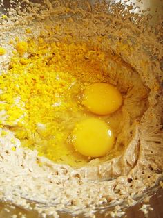 two eggs are in a bowl with some flour on the side and one is yellow