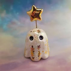 a small white elephant figurine with a star on top