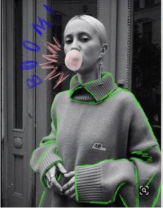 a black and white photo of a woman with bubble gum on her nose in front of a building