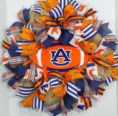 an orange, white and blue wreath with the word auburn on it's center