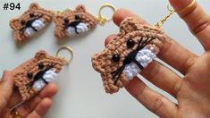 crocheted cat keychain being held by someone's hand