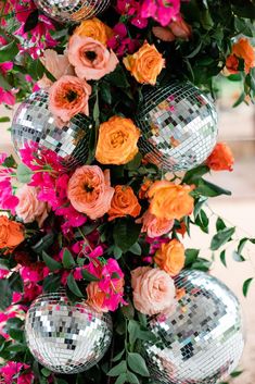 an arrangement of flowers and disco ball decorations